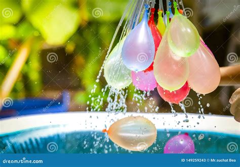 Colorful Water Balloons Play In Plastic Swimming Pool Stock Image