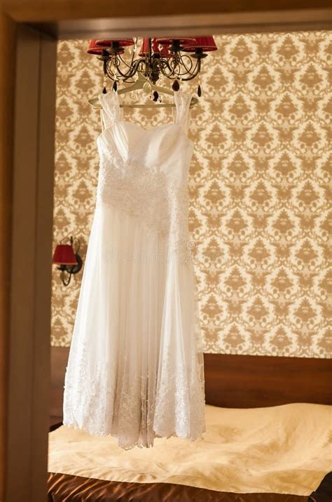 Beautiful Wedding Dress Hanging On A Lamp In The Stock Photo Image Of