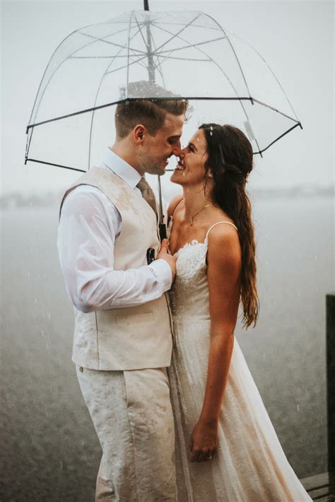 Bohemian Couple On Beach In Rain With Umbrella