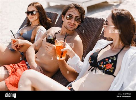 A Man Flirting With Girls On The Beach Stock Photo Alamy