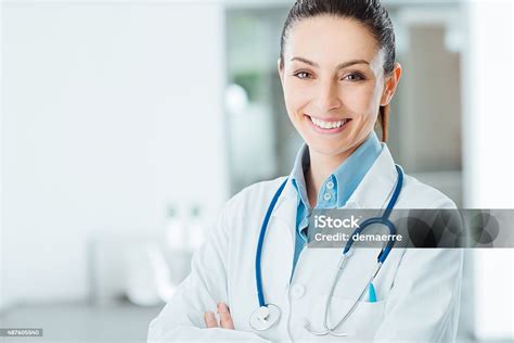 Confident Female Doctor Posing In Her Office Stock Photo Download