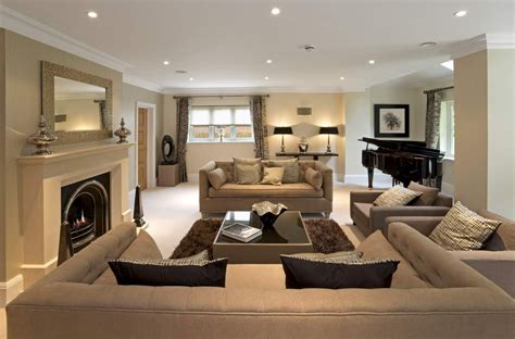 Lounge-like living room with brown sectional sofa, fireplace, recessed