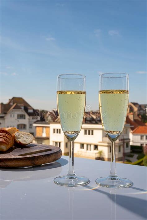 Drinking Of Brut Champagne Sparkling Wine In Flute Glasses On Outdoor