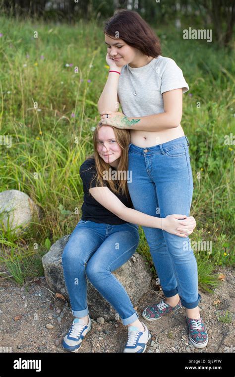 Two Teenage Girls Are Best Friends Hugging At The Glade Stock Photo