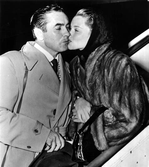 tyrone power gets a kiss from wife linda christian