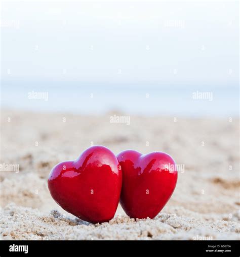 Two Red Hearts On The Beach Symbolizing Love Stock Photo Alamy
