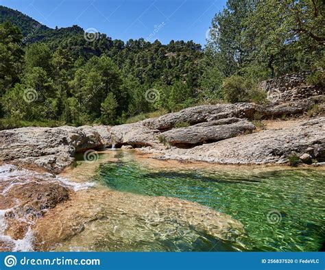 Small Waterfall In A Natural Pool In The Ulldemo River At The Pesquera