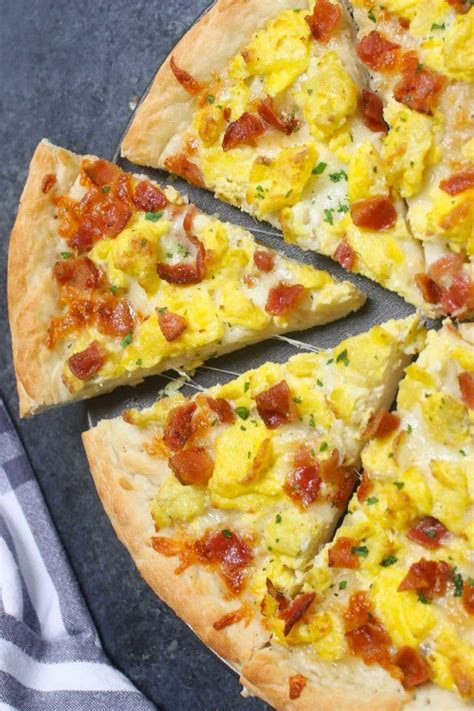 easy breakfast pizza recipe begins with homemade pizza dough topped with crisp bacon bits