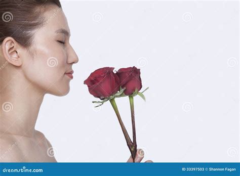 Beautiful Young Woman With Eyes Closed Smelling A Red Rose Studio Shot