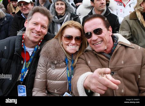Arnold Schwarzenegger And Girlfriend Heather Milligan Sitting In The Vip Grandstand At The 2014
