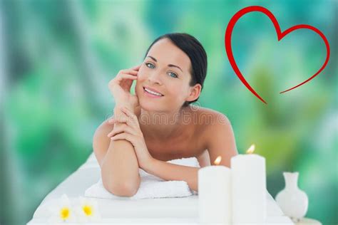 Composite Image Of Beautiful Brunette Relaxing On Massage Table Smiling