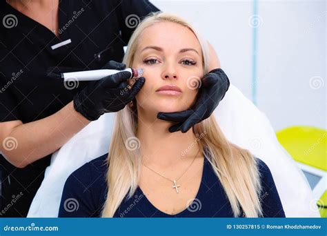A Cosmetologist Carries Out Procedures On The Patient`s Face With A
