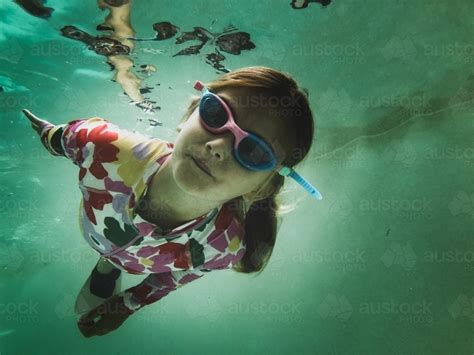 Image Of Young Girls Swimming Underwater In Pool Wearing Floral Swim