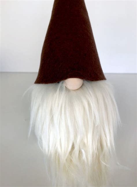 A Gnome S Head With Long White Hair And A Brown Hat On Top Of It