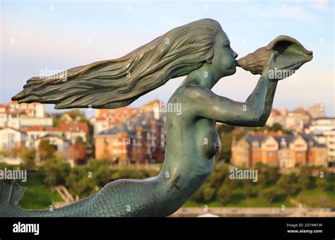 Bronze Mermaid Sculpture With Long Flowing Hair Blowing Into A Conch
