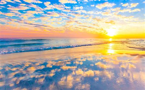 Clouds Reflected On The Beach At Sunset