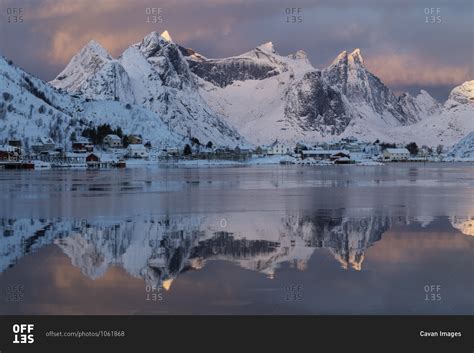 Low January Sun Illuminates Distant Mountain Peaks Across Reinefjord