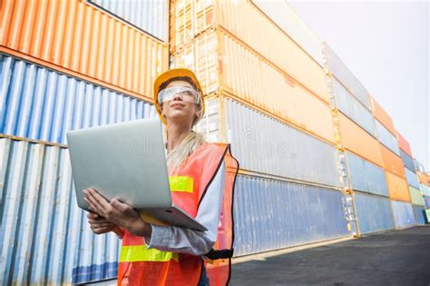 foreman woman worker working checking at container cargo harbor holding laptop computer to