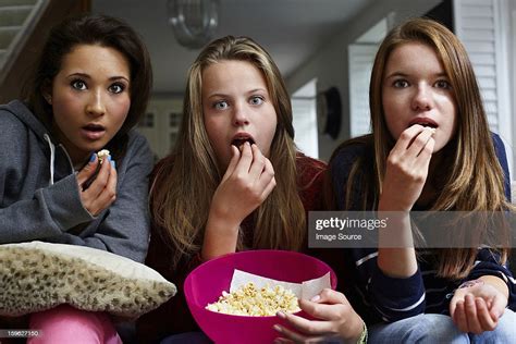 Teenage Girls Watching Horror Movie With Popcorn Photo Getty Images