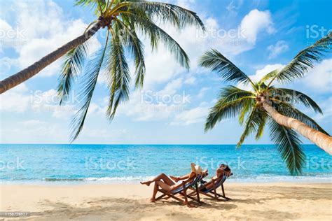 Couple Relax On The Beach Enjoying Beautiful Sea On The Tropical Island Stock Photo - Download ...