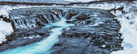 Turquoise Water Flowing Over Rocks Into A River Bruarfoss Iceland