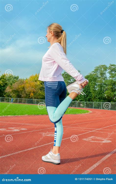 Fitness Woman Stretching Legs Before Run On Outdoors Stock Image