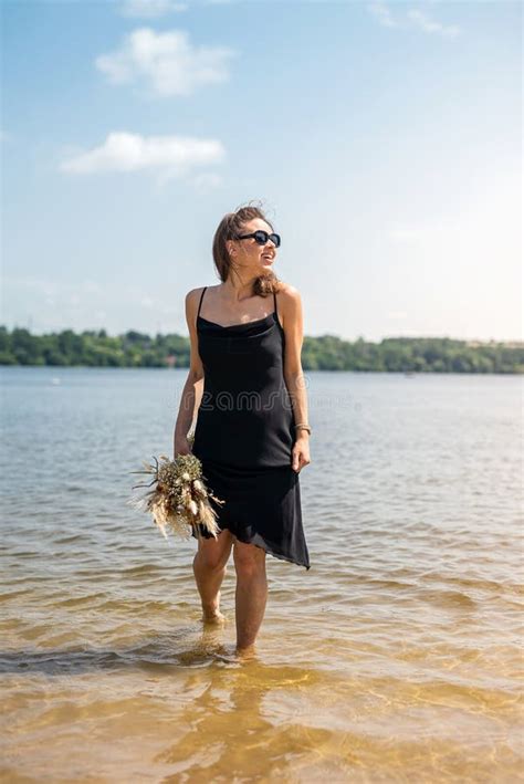 Barefoot Woman Walk In Pond In Black Dress Summer Day Stock Image