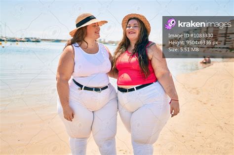 Two Plus Size Overweight Sisters Twins Women Happy At The Beach On Summer Holidays Kraken Images