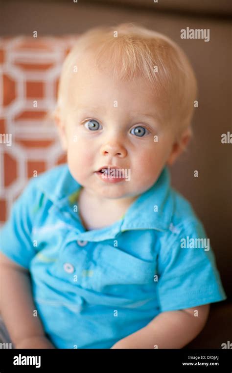 Wide Eyed Baby Boy With Blonde Hair And Blue Eyes Portrait Close Up