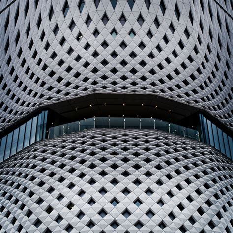 The Facade Of A Modern Building With Geometric Patterns On Its Walls