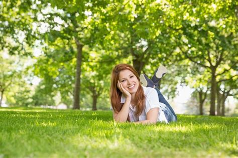 Premium Photo Pretty Redhead Relaxing In The Park