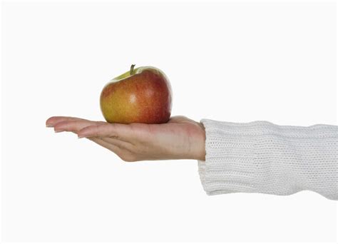 Person Holding An Apple Stock Photo