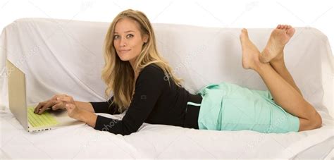 Woman Lying On Sofa With Laptop Stock Photo Alanpoulson