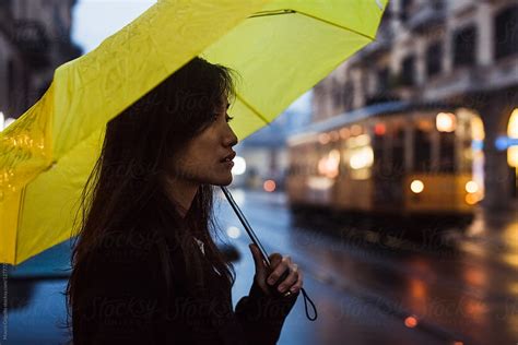 Asian Woman Going Out During A Rainy Day By Stocksy Contributor Mauro Grigollo Stocksy