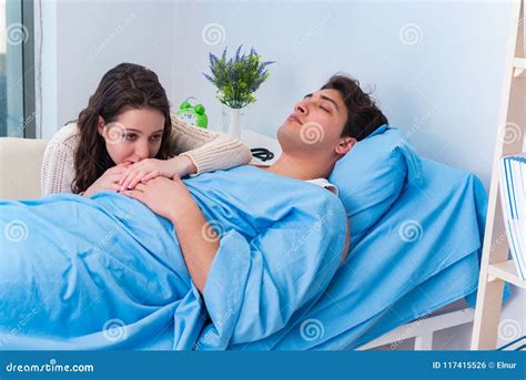 Wife Visiting Husband In Hospital Senior Couple Holding Hands On Hospital Bed For