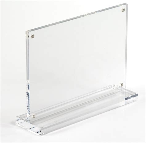 The Acrylic Picture Frame Is Made Of Clear Plastic And Held Together