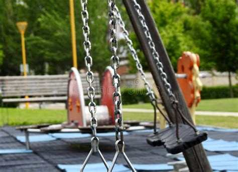 Empty Swings In A Playground Stock Photo Image Of Vegetation Area