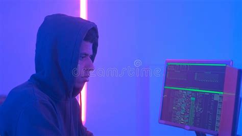 Hacker Working Place Hacker Working In A Room With Colored Neon Lights