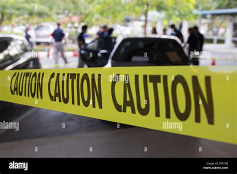 Caution Tape Protect Area Of Crime Scene Investigation With Forensic And Law Enforcement