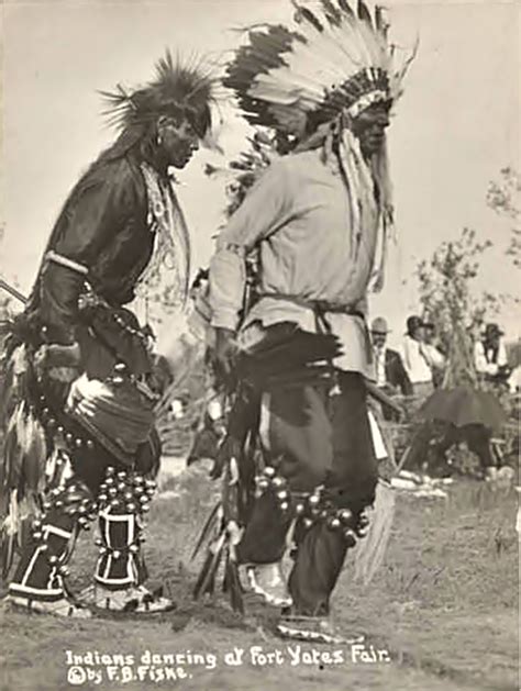 Two Unidentified Sioux Men Wearing Headdresses Bells And Feather