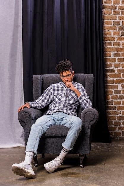 Free Photo Young African Man Sitting On Chair In Front