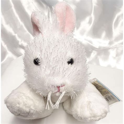 a white stuffed rabbit sitting on top of a table