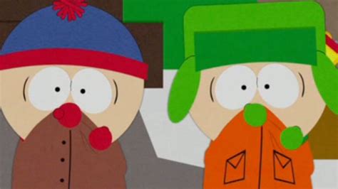 Two Cartoon Characters Wearing Hats And Scarves In Front Of A Wall With
