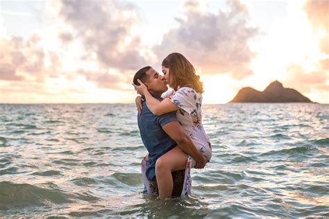 A Man And Woman Kissing In The Ocean