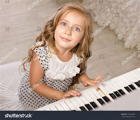 Little Girl Playing Piano Looking Camera Stock Photo 109548086
