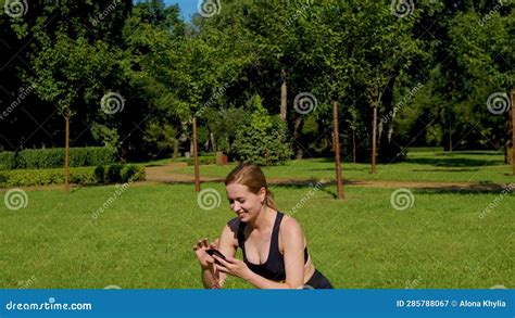 busy with phone pretty active fitness female doing squat exercise outdoors stock video video