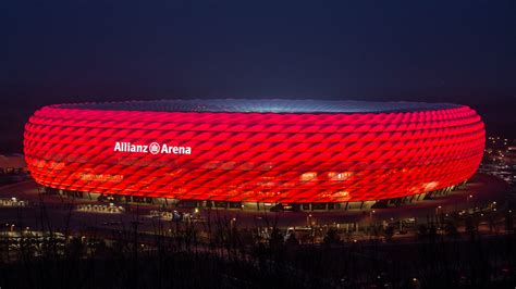 The backlit shell transforms the building into a. Allianz Arena