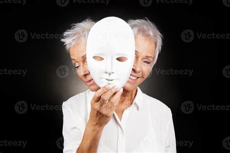 Older Woman Hiding Happy And Sad Face Behind Mask 6240496 Stock Photo
