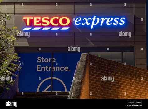 Tesco Express A Small Grocery Supermarket Logo And Sign Illuminated