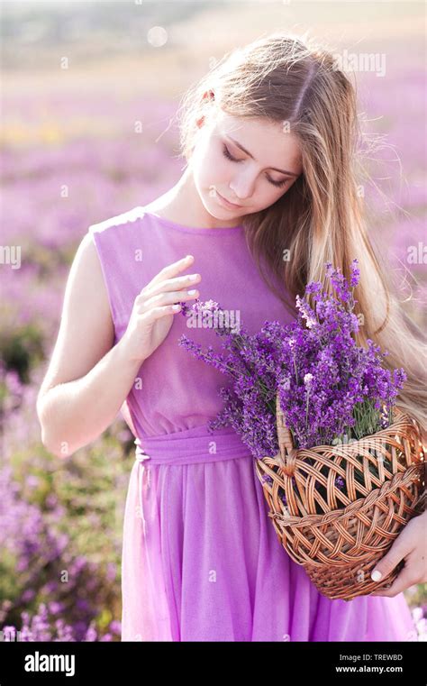 beautiful blonde girl 14 16 year old holding basket with lavender flowers in field pretty girl
